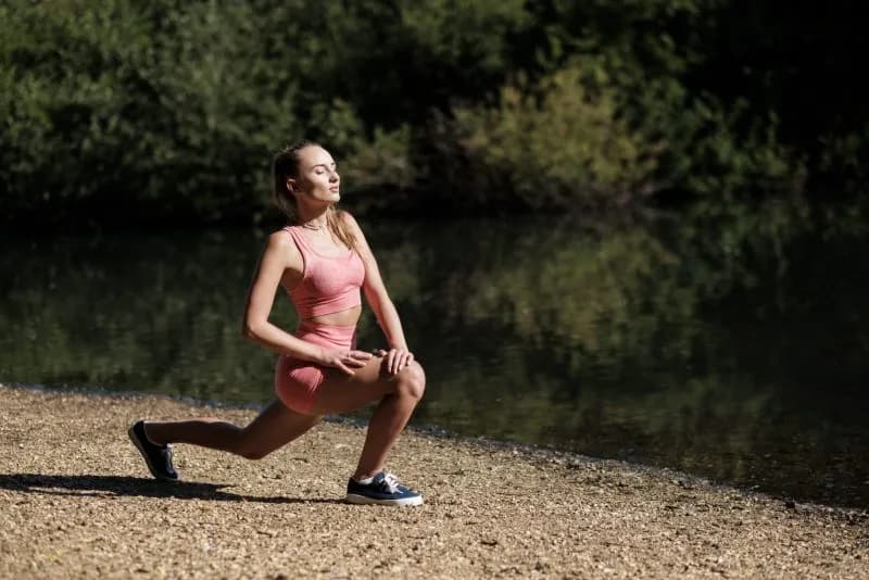a-young-caucasian-woman-is-stretching-on-the-shore-2026-03-18-05-27-16-utc.jpg