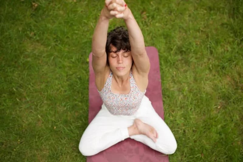 above healthy woman sitting in yoga position in pa 2026 01 05 05 50 05 utc