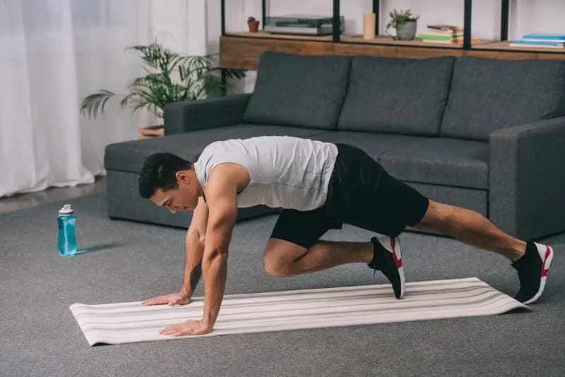 adult-man-exercising-on-a-yoga-mat-at-home-2026-03-12-23-50-42-utc-1.jpg