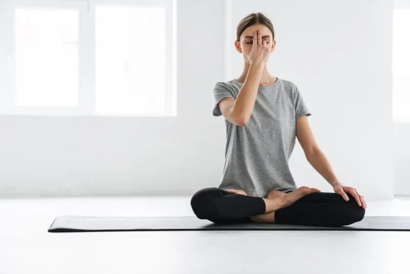 attractive young woman practicing meditation 2026 01 08 05 30 37 utc 1 1