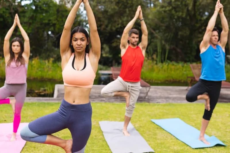 female-instructor-teaching-tree-pose-to-men-and-wo-2026-03-25-01-20-39-utc.jpg