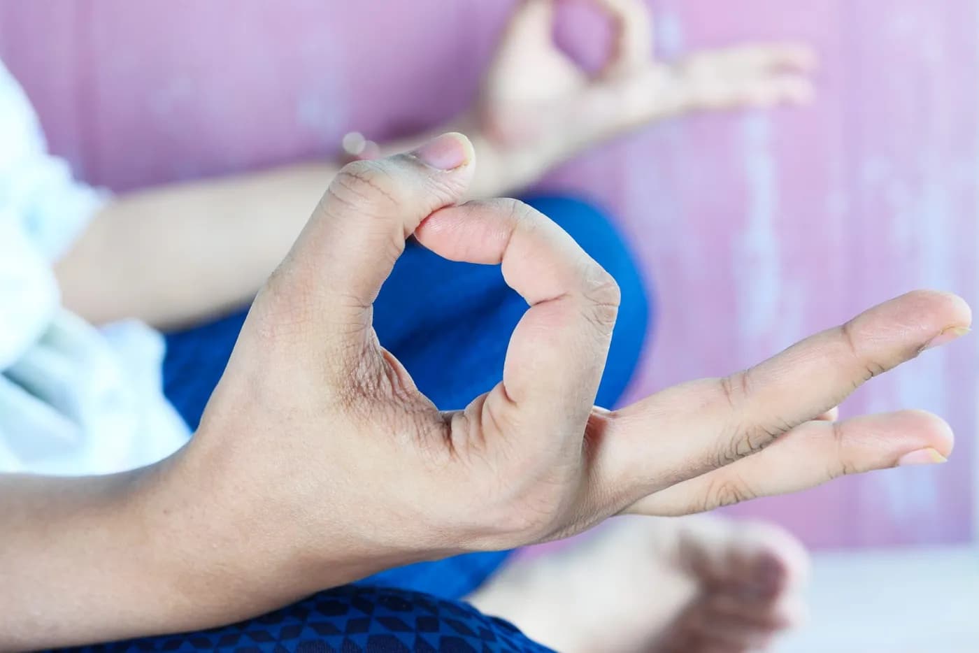 Young woman meditating in lotus pose with hands in Gyan Mudra