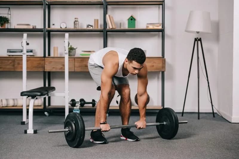 handsome bi racial man workout in home gym