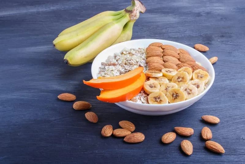 Healthy breakfast bowl with bananas, almonds, and paneer for strength training nutrition
