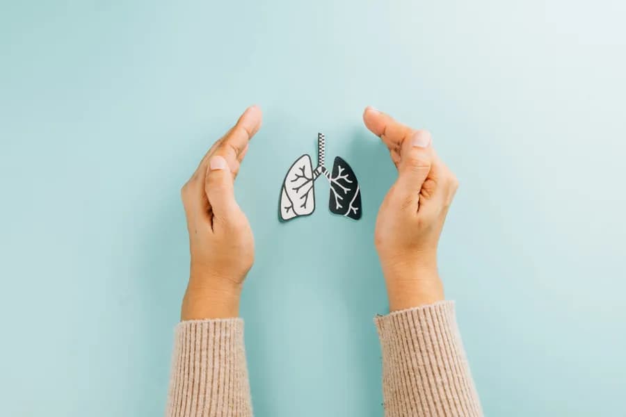 Person practicing deep breathing to strengthen lung health