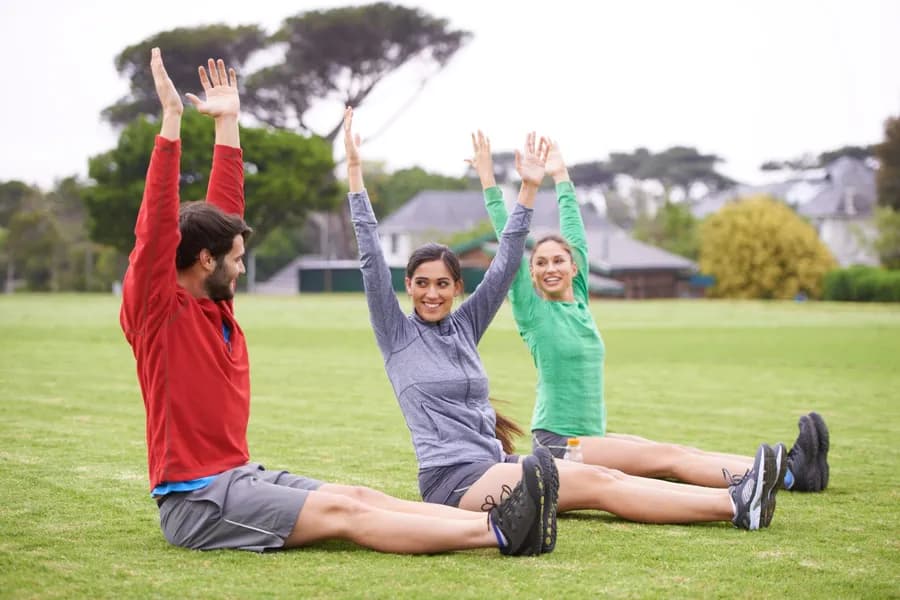 Friends enjoying a stretching session outdoors