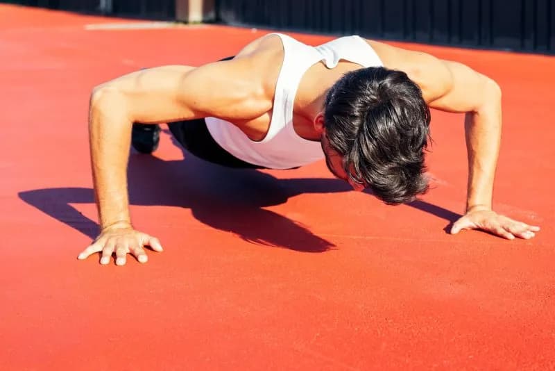 man does push ups on a red sport court 2026 01 08 06 28 37 utc