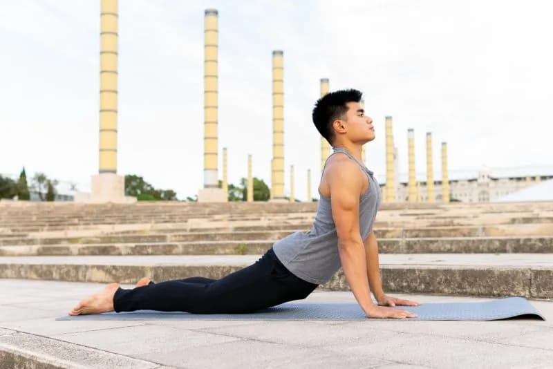 man doing yoga outdoors under an overcast sky 2026 03 27 00 32 49 utc