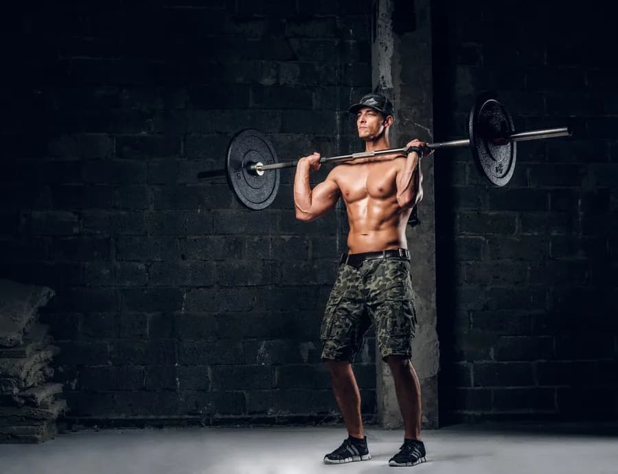 Person lifting a barbell to build muscle mass