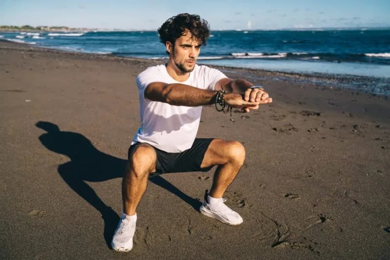 muscular man exercising on sandy beach 2026 01 09 07 28 01 utc