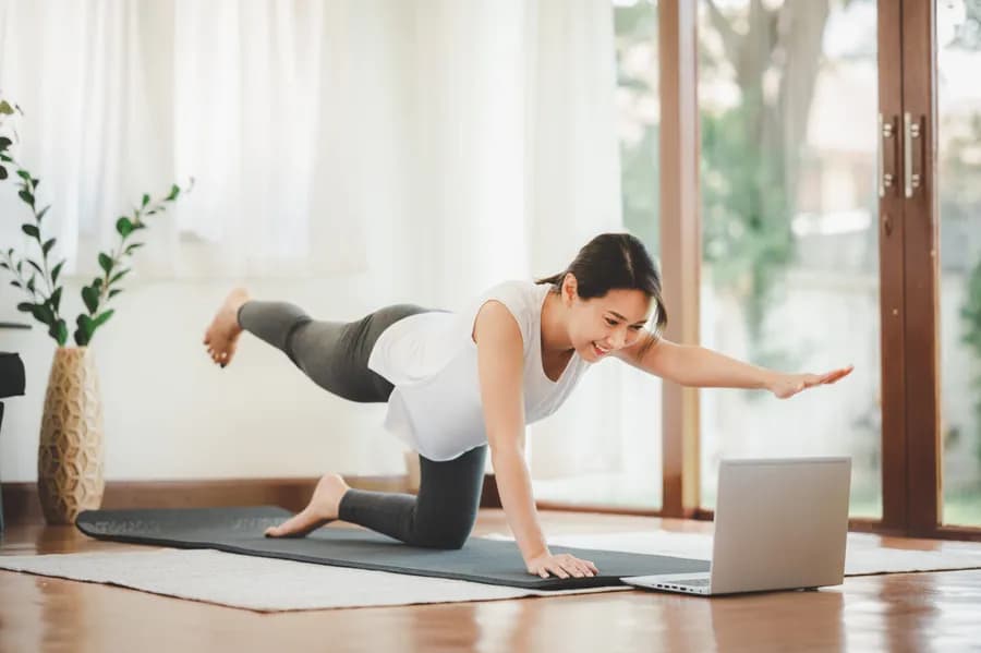 Woman exercising at home during a quad workout