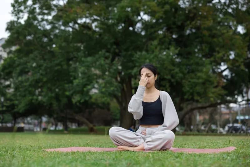 sport woman practicing pranayama breathing in gree 2026 03 11 19 03 12 utc