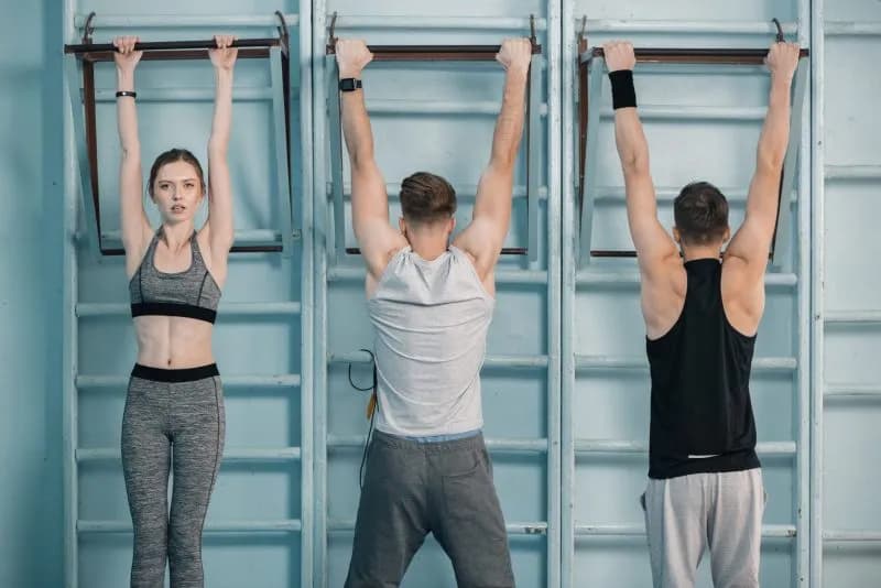 sporty men and woman hanging on sport equipment in 2026 03 12 23 53 14 utc