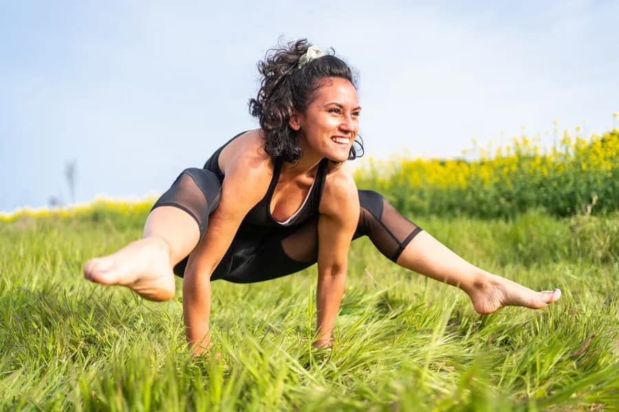 Tittibhasana (Firefly Pose) — advanced yoga arm balance with legs extended horizontally