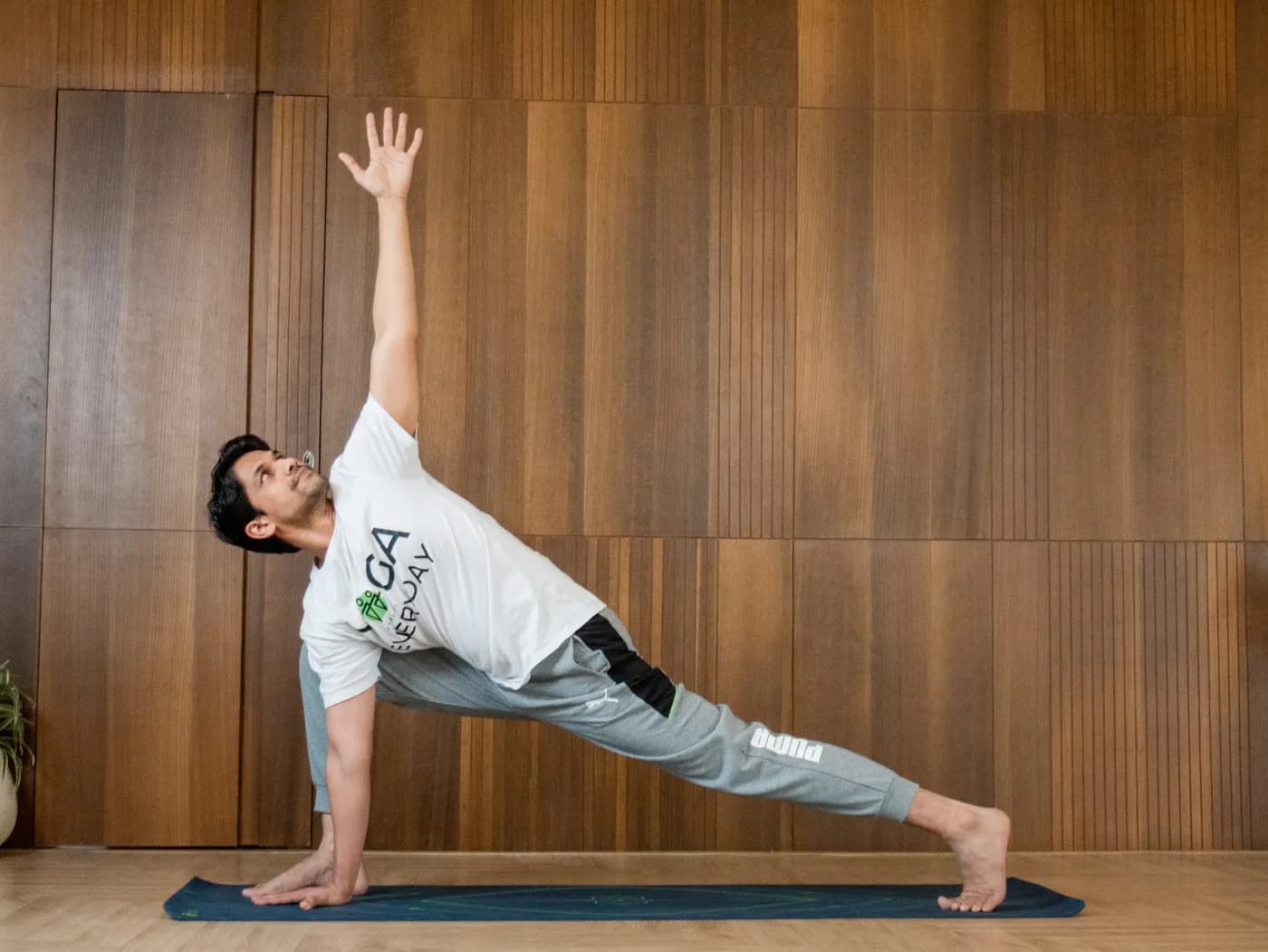 Woman practicing Utthita Parsvakonasana (Extended Side Angle Pose) in a wide-legged standing stance