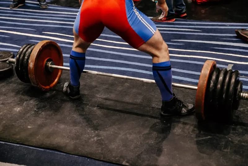 weightlifter preparing to lift a heavy barbell