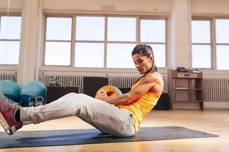 Young woman doing a core workout at the gym