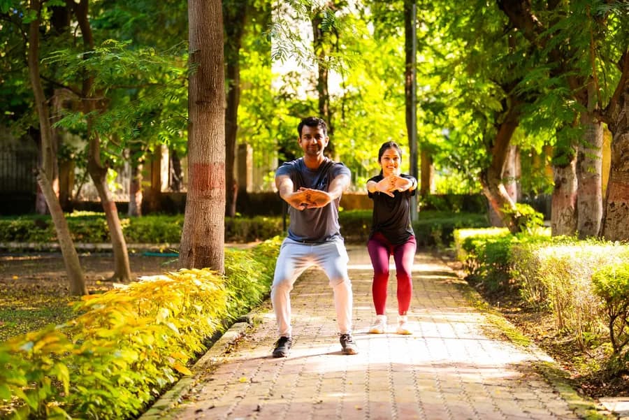 Energetic young couple doing aerobic exercise together in the park