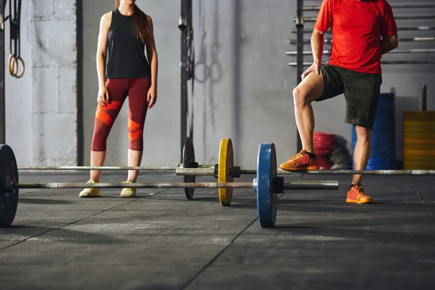 Adults exercising with barbells at the gym