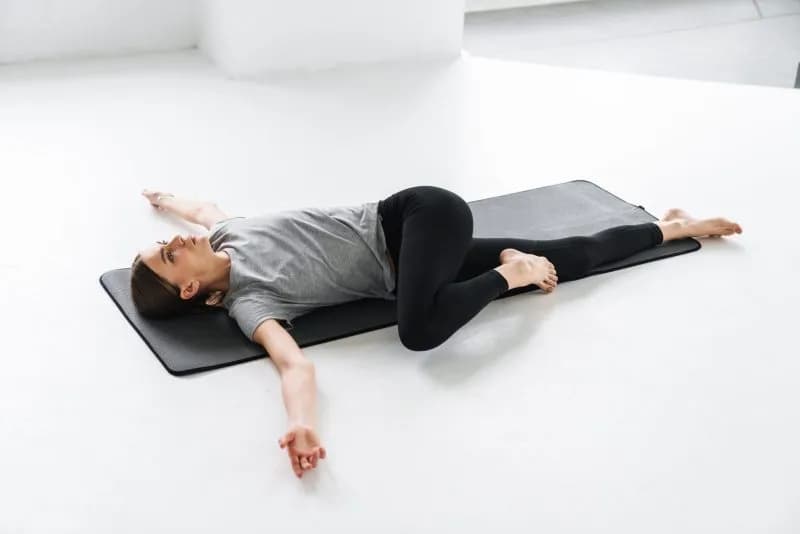 woman-doing-spinal-twist-exercise-on-yoga-mat-2026-01-08-05-35-08-utc-1.jpg