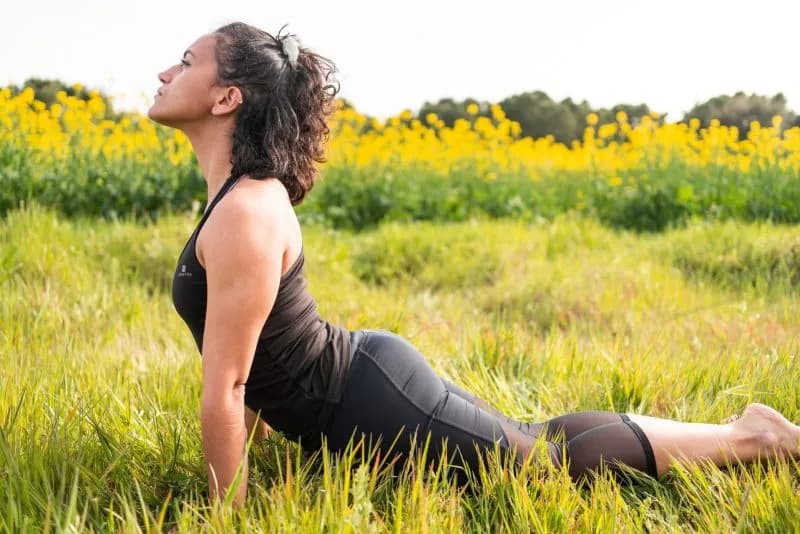woman doing yoga in a field of flowers 2026 03 17 00 05 15 utc