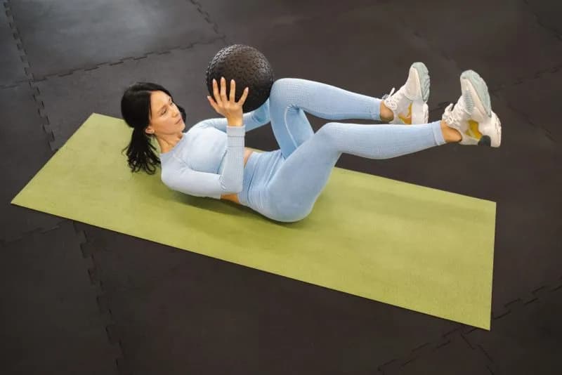 woman exercising on mat with medicine ball 2026 01 05 06 24 34 utc 1