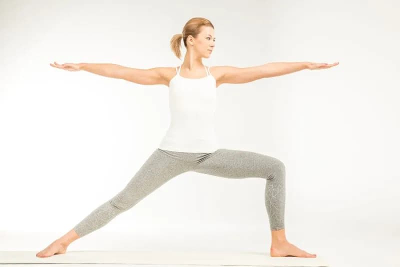 woman practicing yoga standing in variation of war 2026 03 12 23 54 47 utc
