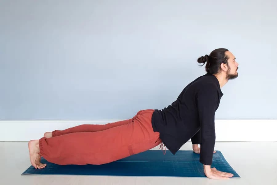 Young man performing a yoga pose
